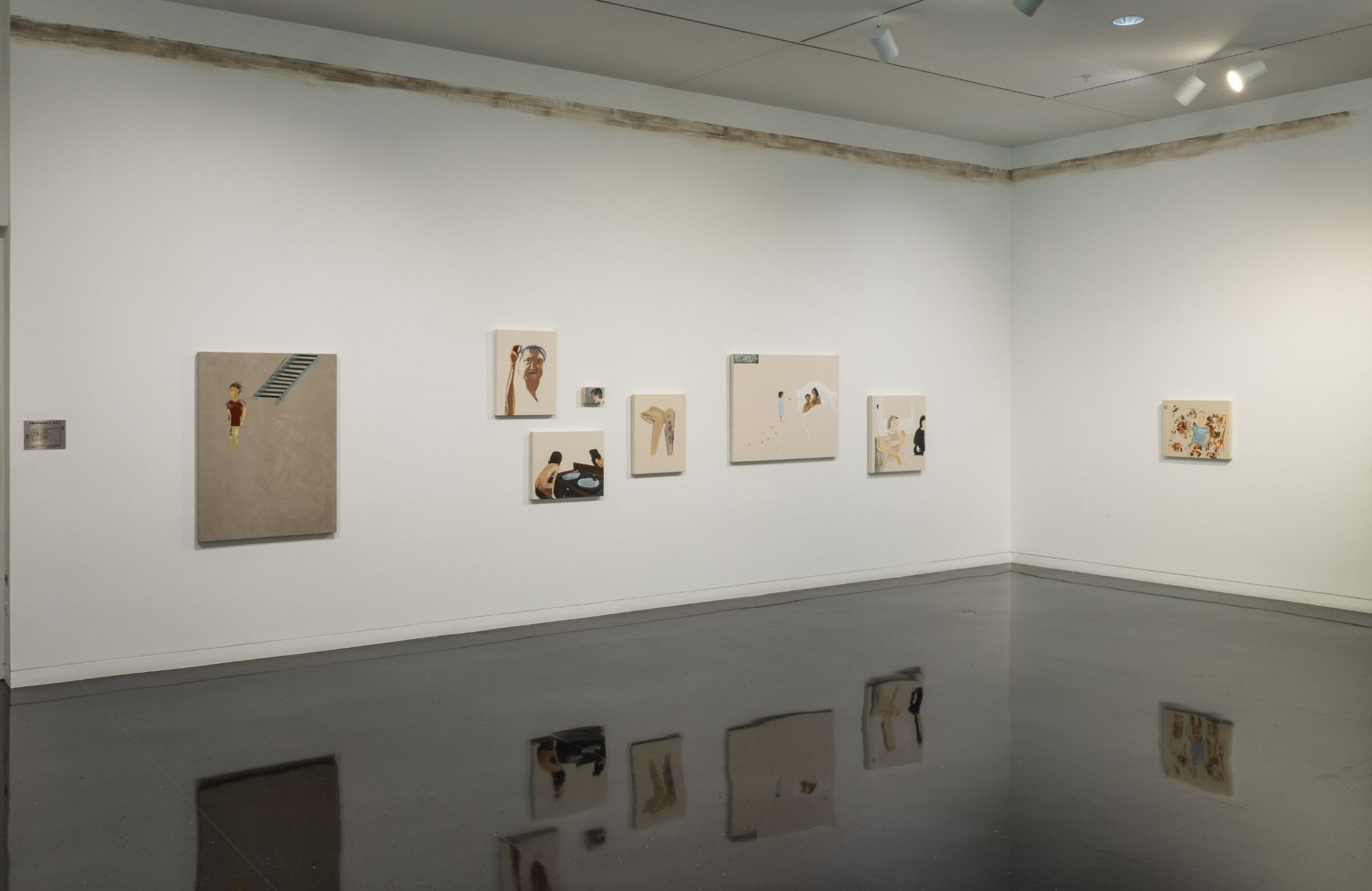 A white gallery wall with six paintings of varying sizes. At the top of the wall, there is a faded brown streak painted to resemble a flood line.