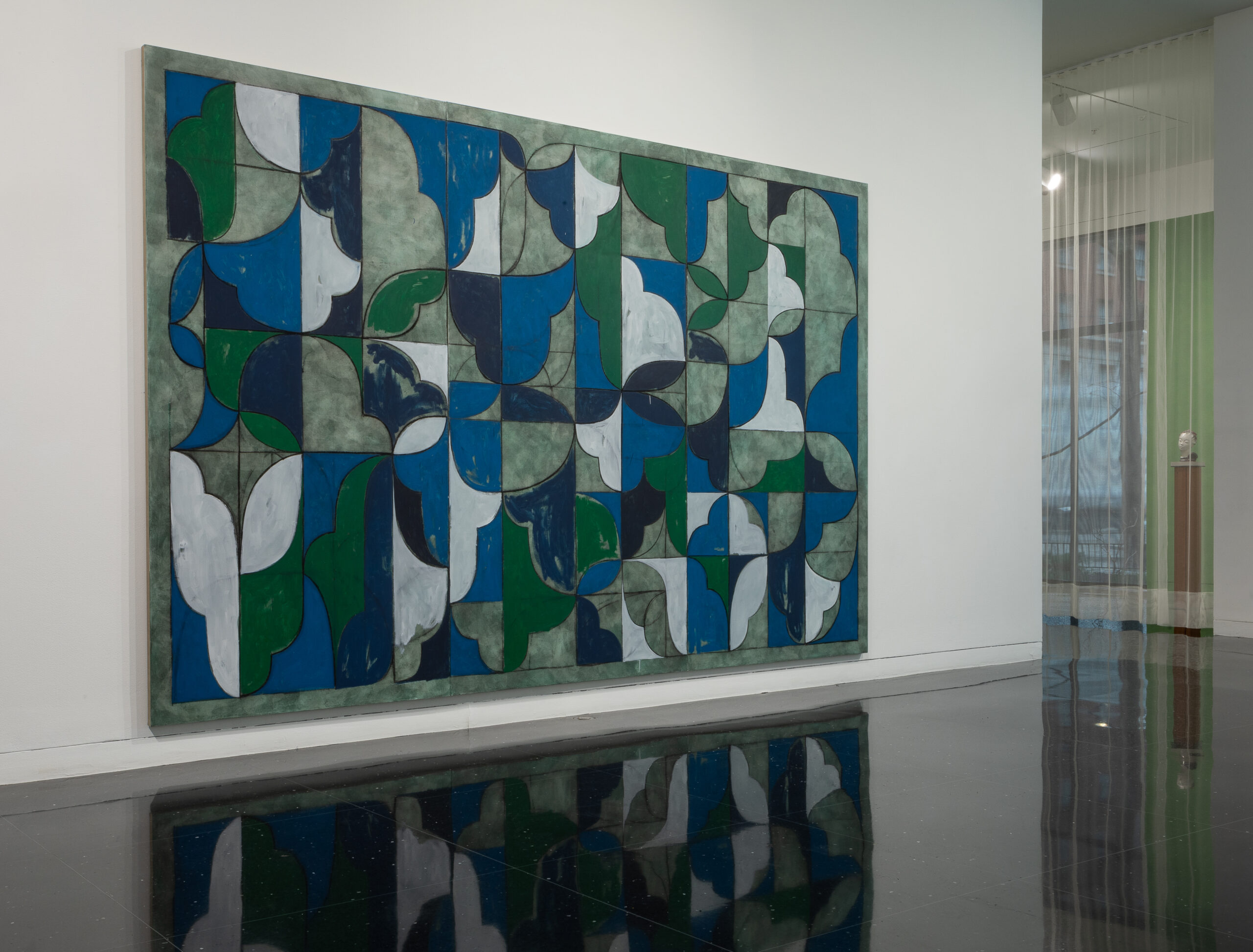 A large, nearly wall-sized abstract painting with blue, white, gray, and green interlocking curvilinear formsdisplayed on a white gallery wall.