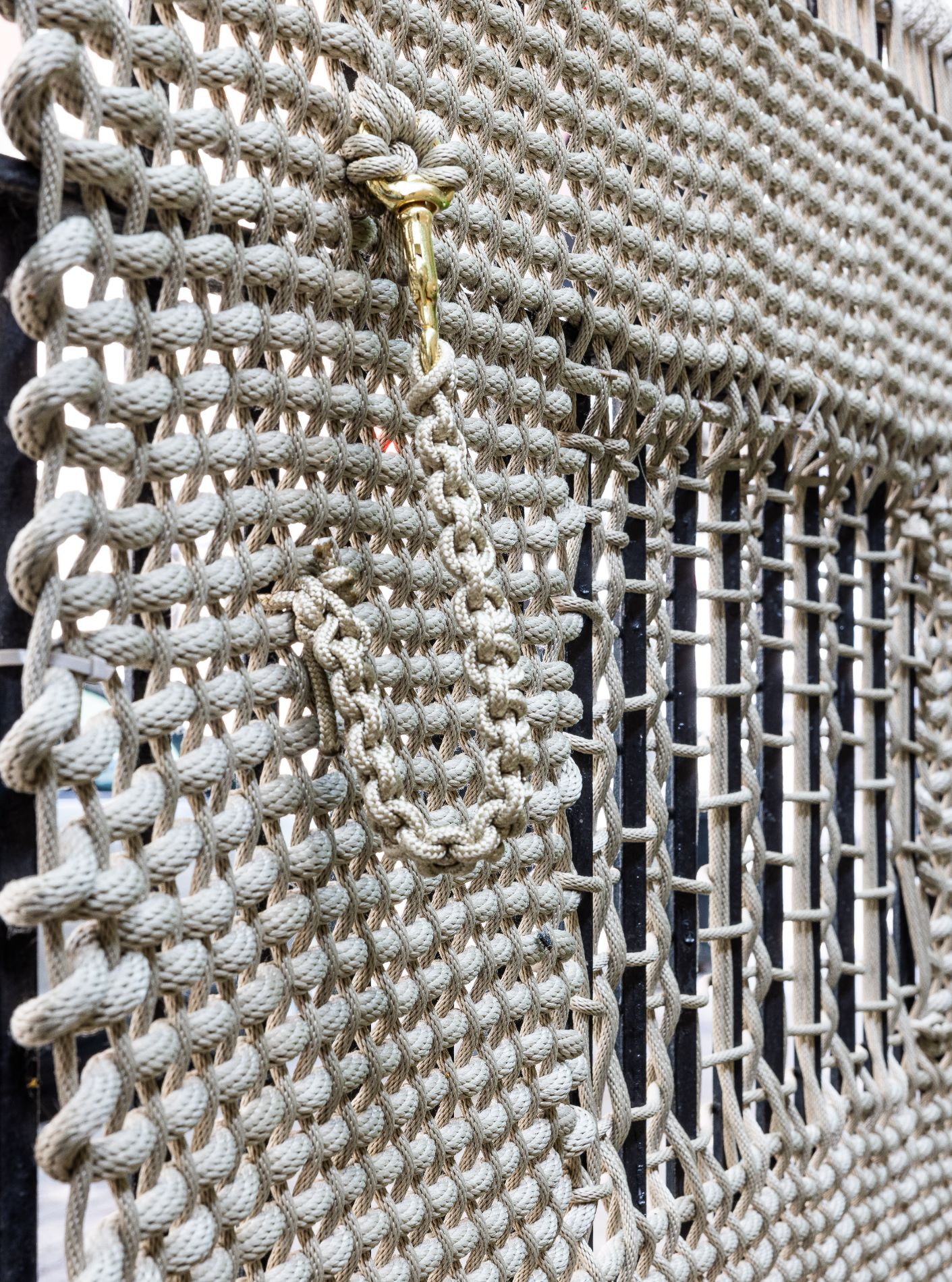 Close-up Detail, Yasmin Spiro: Groundation , 2023. Garden fence and chain on St. Clair St, Chicago.