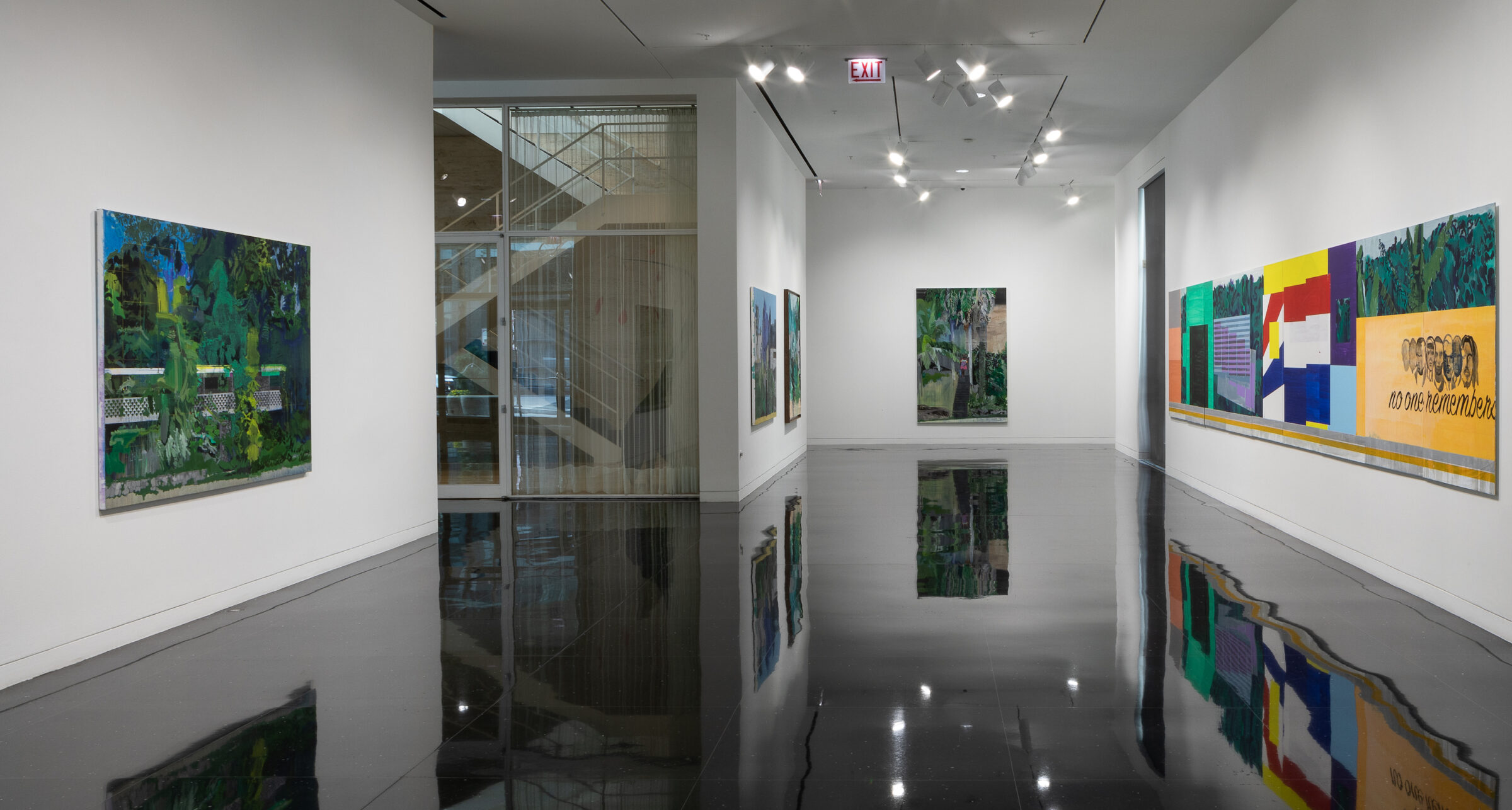A white gallery space in which five mostly green landscape paintings hang. On the far right wall is a large banner-like painting spanning the length of the wall, the far end of which reads "no one remembers" in black cursive script.