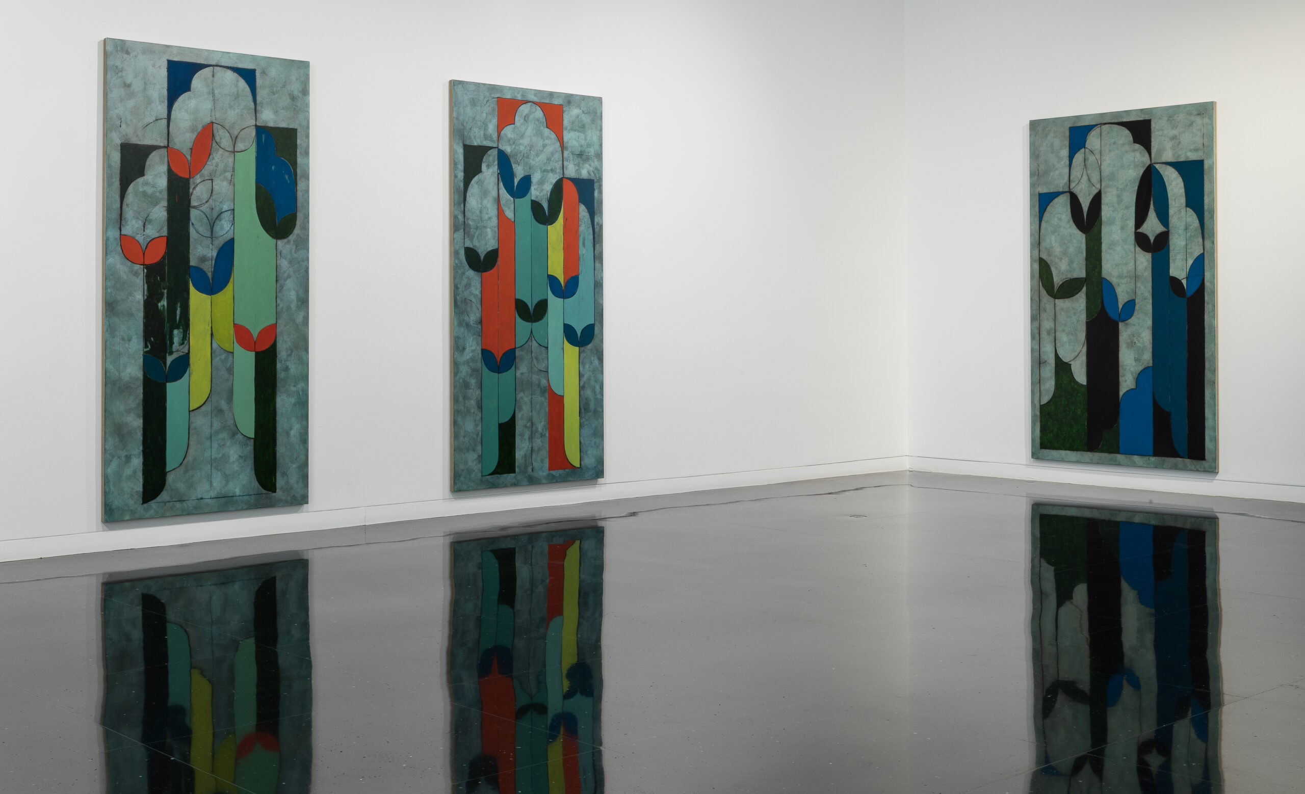 Gallery interior with three large decorative abstract paintings hung on the wall.