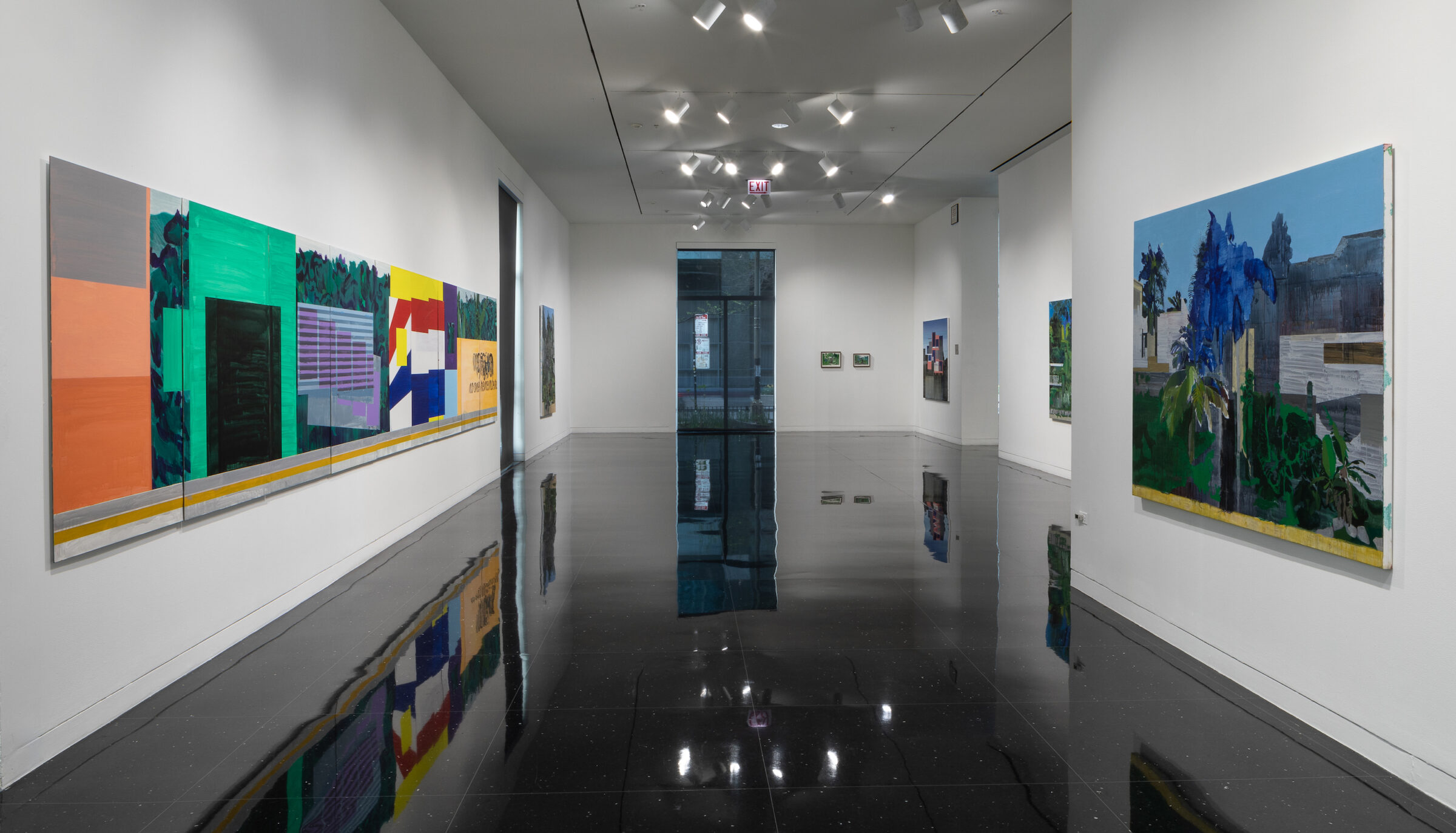 A white gallery space in which five mostly green landscape paintings hang. The image on the left wall is made up of nine separate canvases hanging flesh with each other that create an abstract patterned banner.