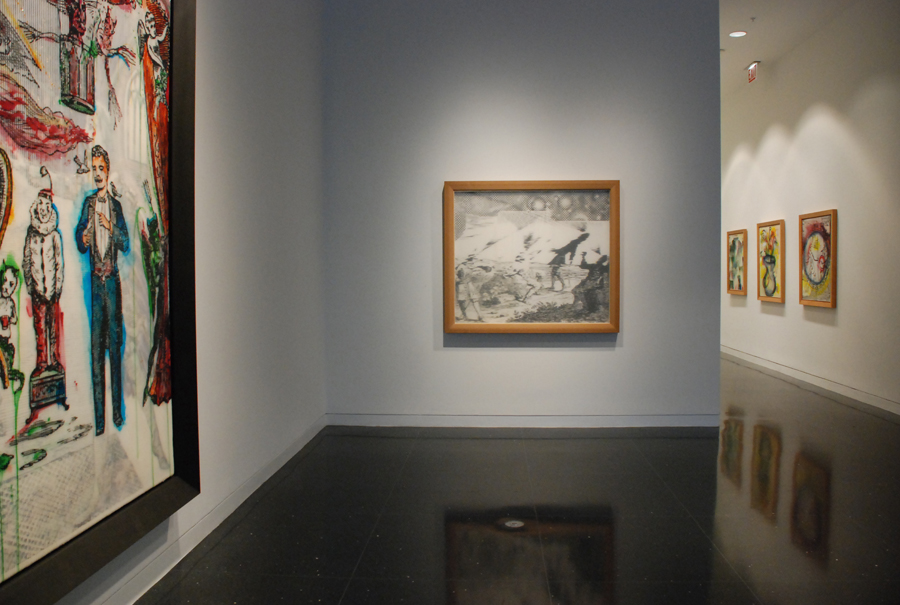 Two adjoining white gallery walls on which two collages in wood frames are hanging. A detail on the leftmost artwork shows a figure in a tuxedo standing next to a white clown in a large ruffle collar. The black and white image on the right depicts a stylized confrontation or battle scene.