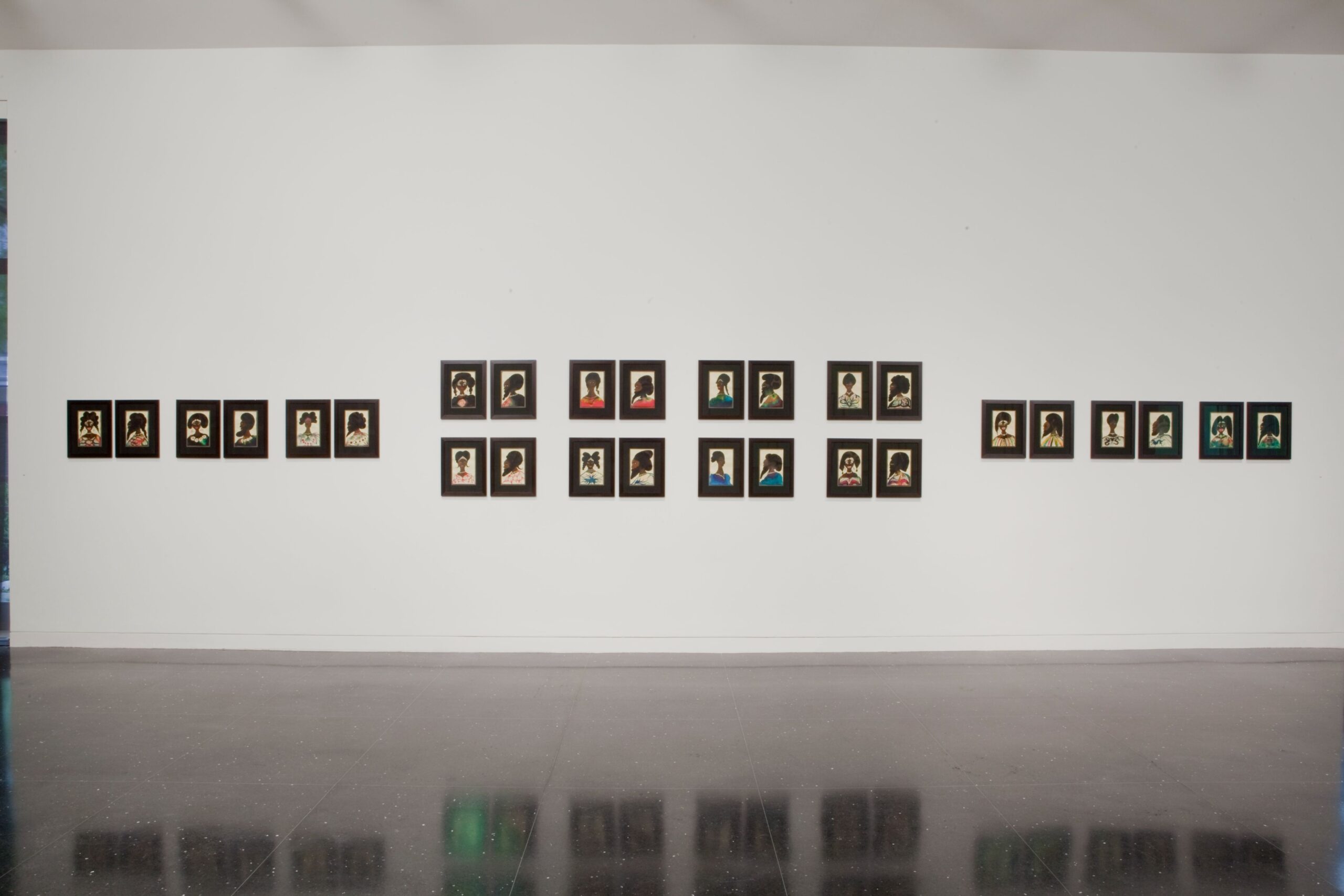 Two rows of six small watercolor portraits of Black subjects in black frames flank the left and right sides of four groups of similar portraits arranged in grids of four.