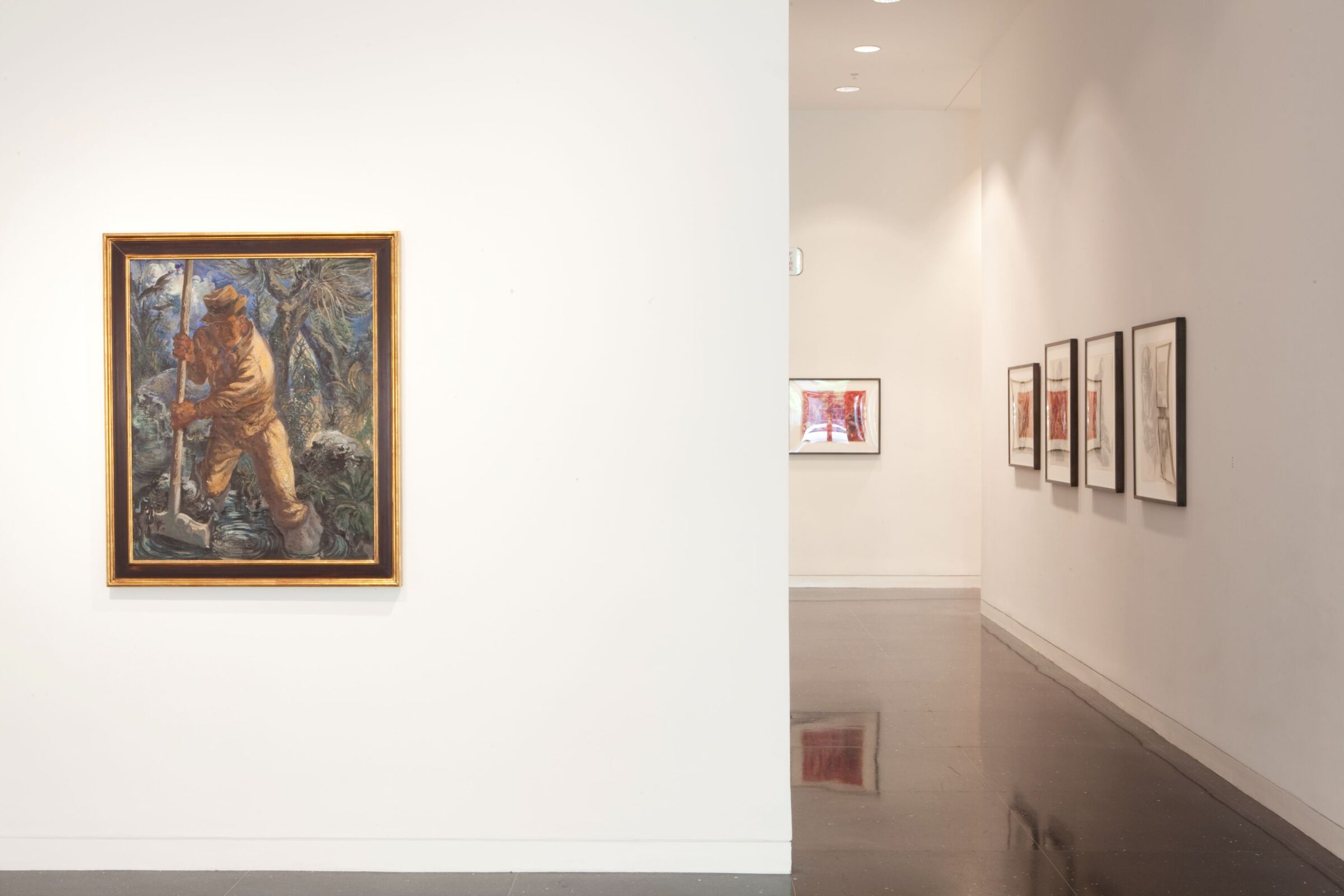 A white gallery space with several framed artworks on the walls. To the right and closest to the viewer is a painting of a figure shoveling mud set inside a gold frame.