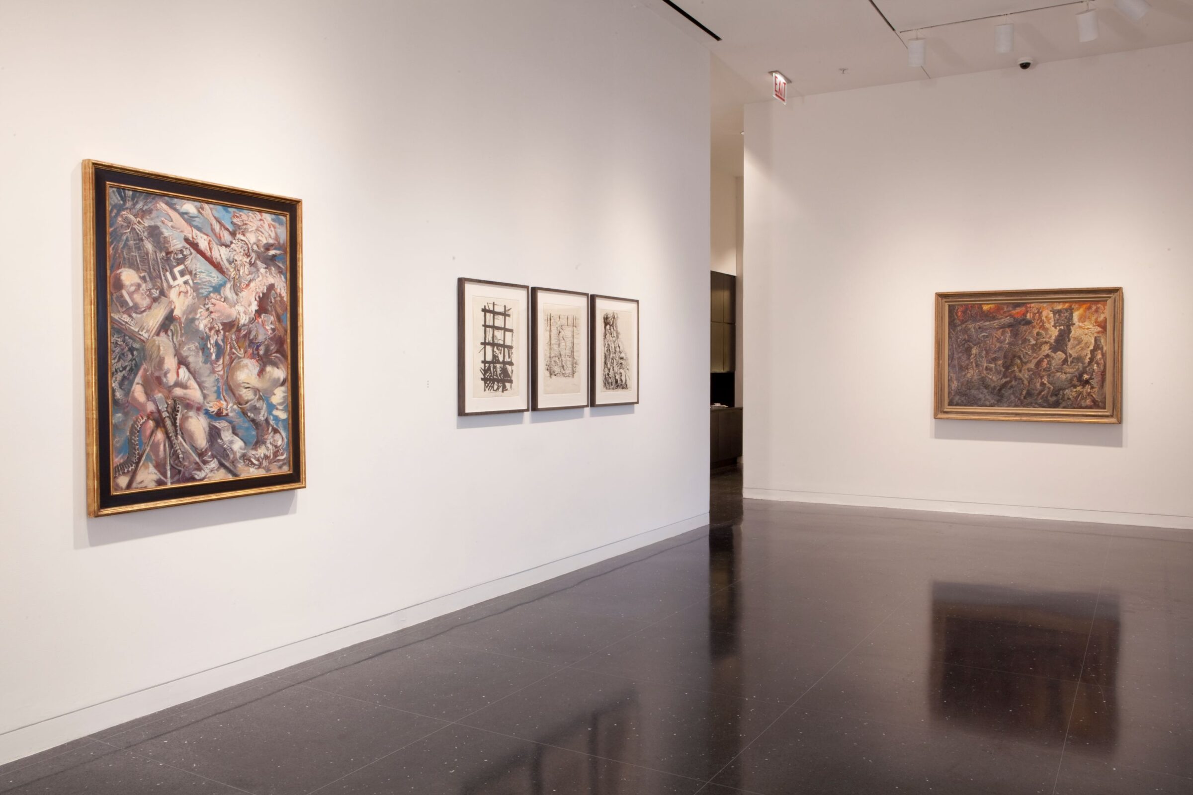 A large painting featuring Nazi and fascist imagery hangs in a gold frame to the viewer's left on a white gallery wall. To the right of this painting are three prints in black frames. On a far wall, a painting depicting a battle scene hangs in a gold frame.