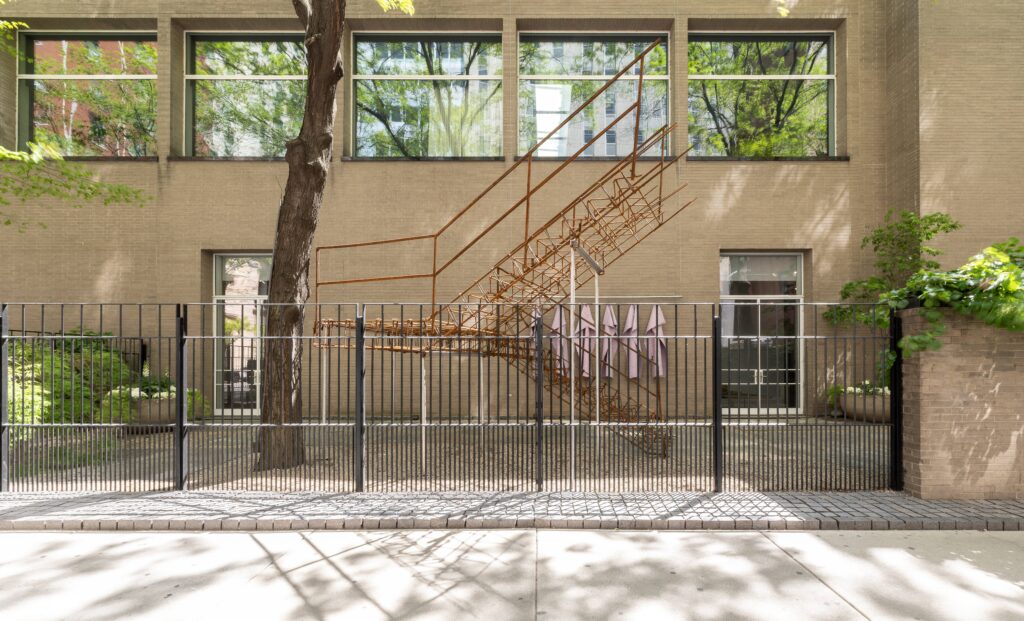 a wrought iron staircase to nowhere in front of a building